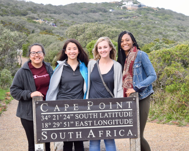 group of cape town students standing in front of sign for cape point hike