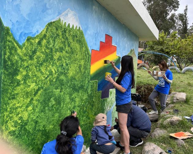 students paint a rainbow mural