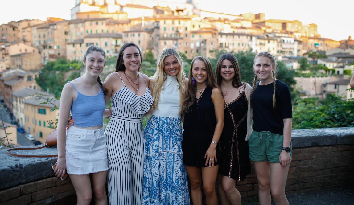 a group of students pose for a photo in Siena
