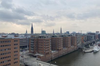 Skyline of Hamburg including the river, buildings, and spires from older churches and buildings.