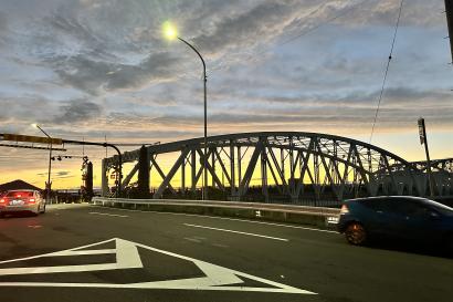 A bridge over the Kiso River in Inuyama with a sunset behind it. 