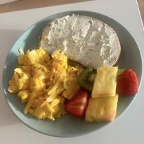 Scrambled eggs, toast, and fruit for breakfast