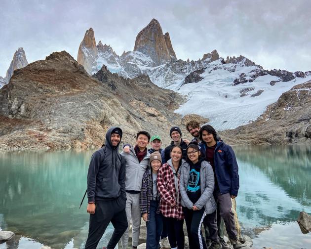 A group of students standing in front of a lake and mountains in Argentina's Patagonia