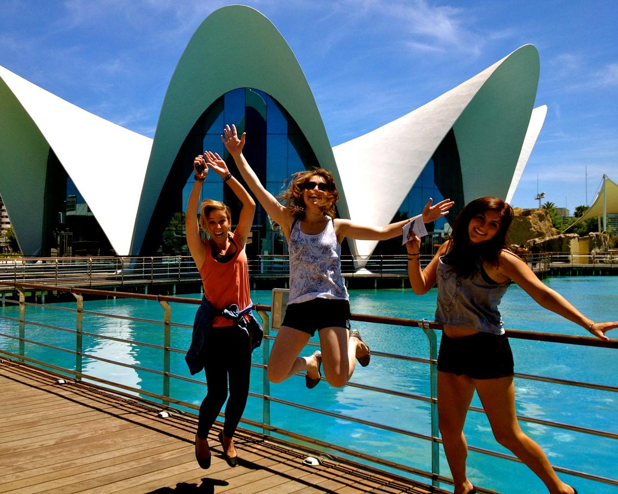 Three students jump at the Valencia Ciudad de artes y ciencias