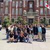 Group of study abroad students posing in front of a University building in Japan
