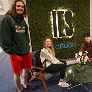 People sitting in front of IES Abroad sign 