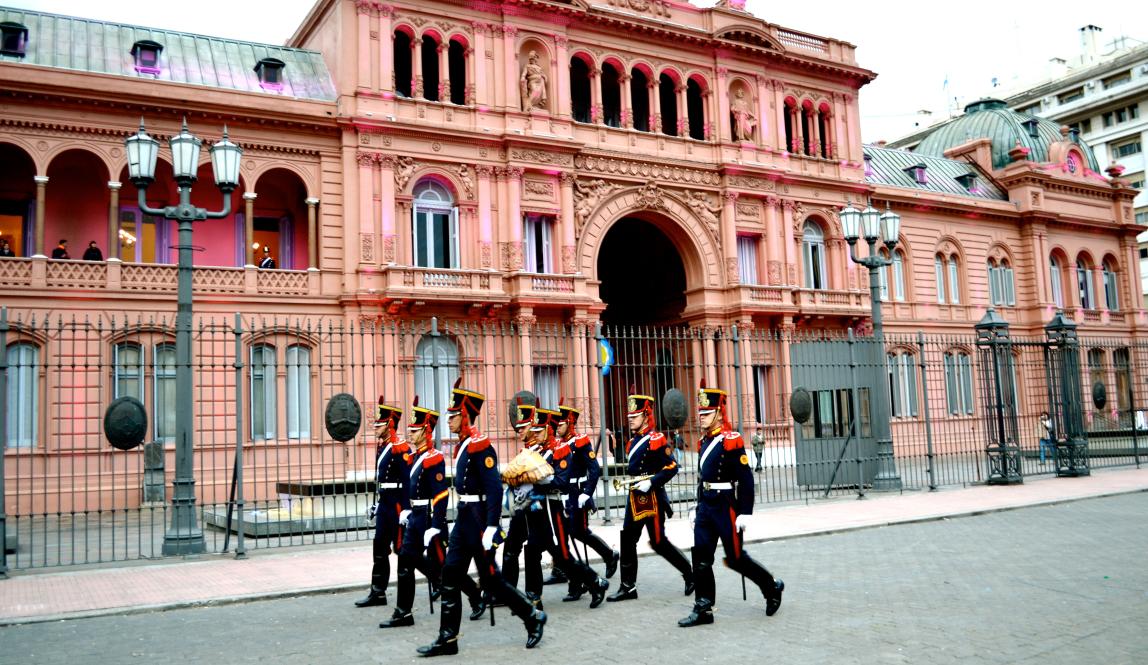 guards walk in front of Casa Rosada in Buenos Aires