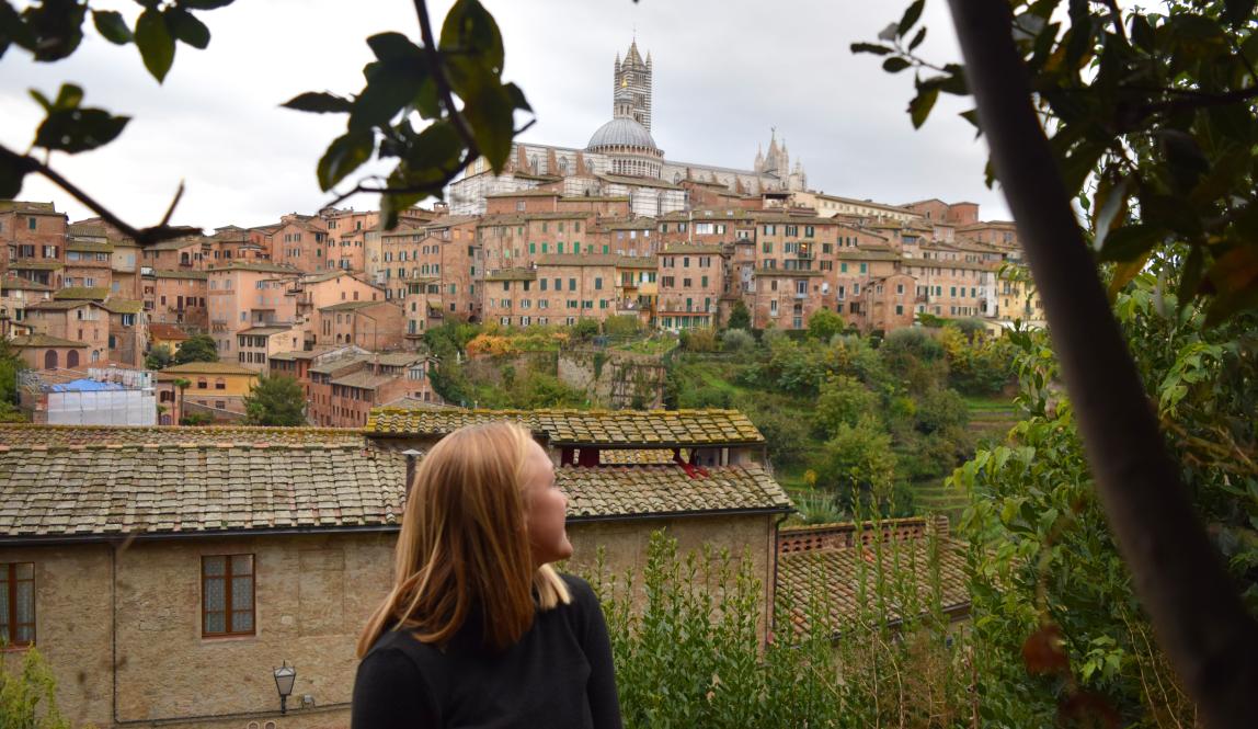 a student looking over their shoulder at Siena
