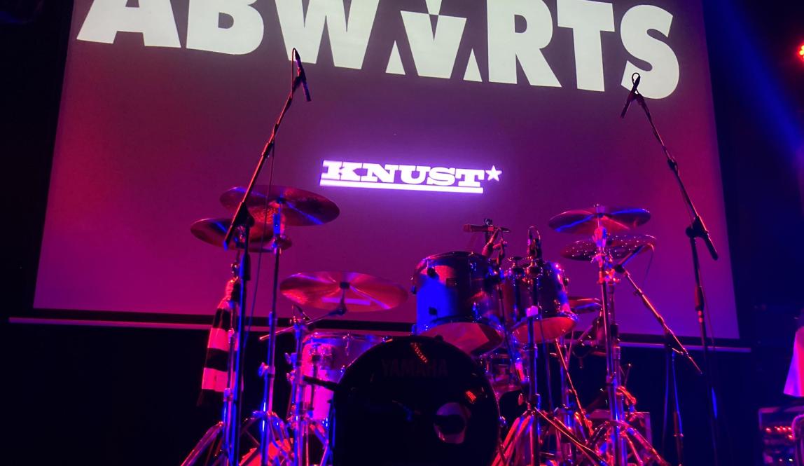 My front row view of the stage for the Abwärts concert, with the band name and a drum set visible.