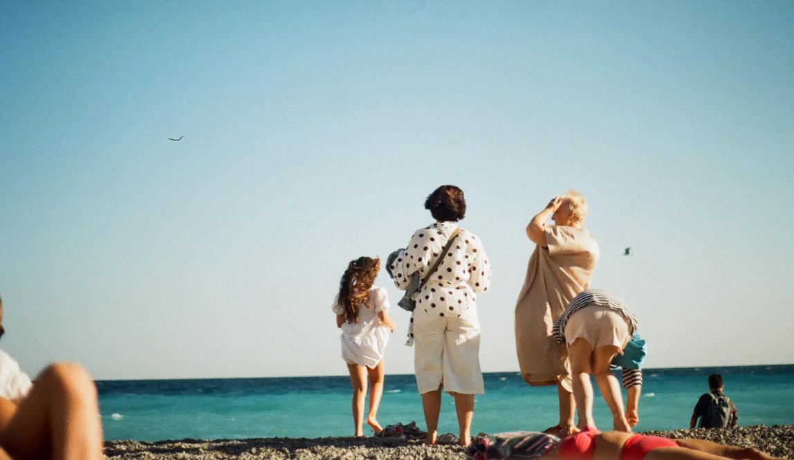 A family stands on the beach in Nice, France.