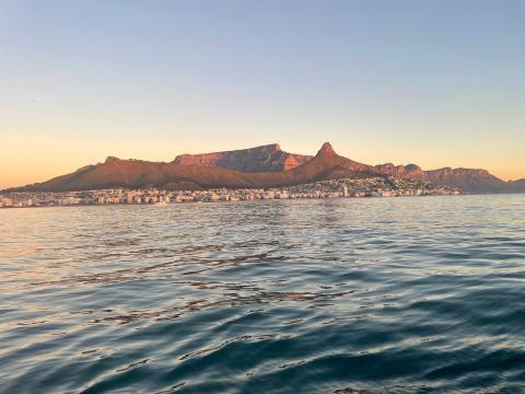 view of the Atlantic Ocean with Table Mountain in the background during sunset
