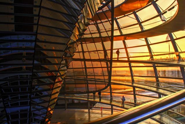 people walking in the dome atop the Reichstag building during sunset