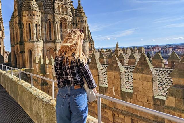 a student looking out over Salamanca from the Old Cathedral