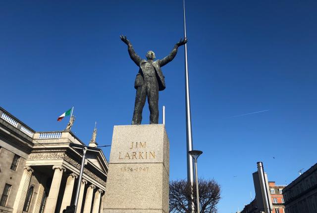 a Jim Larkin statue and the Spire in Dublin