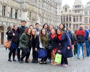 a group of students pose for a photo in Brussels City Center while on a field trip during the European Union program