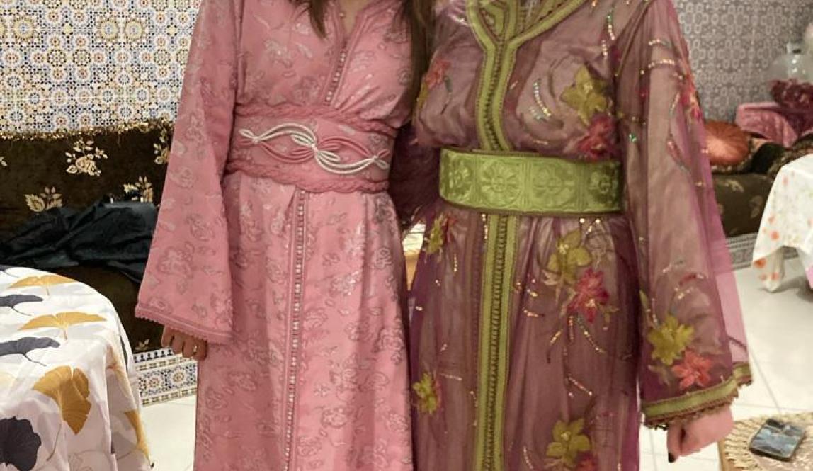 Two young people dressed in colorful formal Moroccan caftans