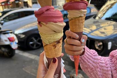 Two students holding large gelato cones on the streets of Rome. 