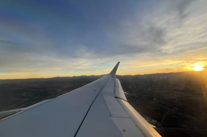 View of an airplane wing from inside the plane.