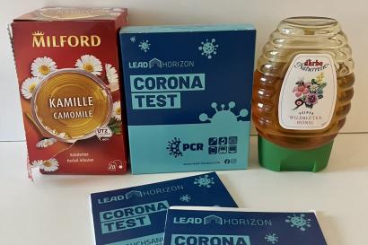 My chamomile tea, honey, and Covid test boxes. 