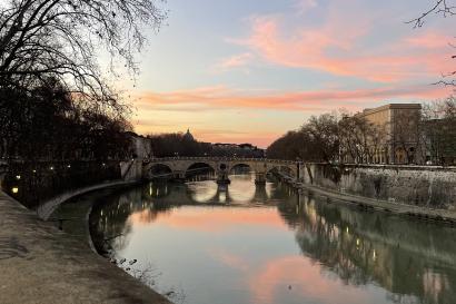 While walking alongside the Tiber River, the sunset illuminates the water in beautiful colors. 