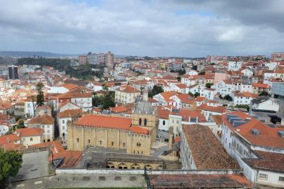 Shown is a sky view of the buildings and their red roofs in the Alfama neighborhood of Lisbon.