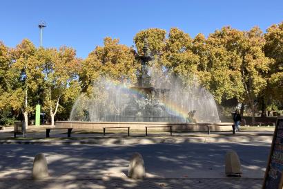 Fountain with many spouts. Sun reflecting off the mist makes a rainbow