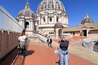 Girl standing on top of Vatican dome.