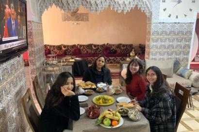 Four girls sitting at a table in a Moroccan Riad