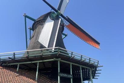 A windmill, green and white, located in Zaans Schanse 