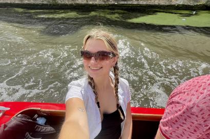 Selfie of a girl wearing sunglasses on a boat in a canal