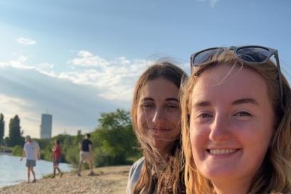 Two young women on the beach smiling at the camera
