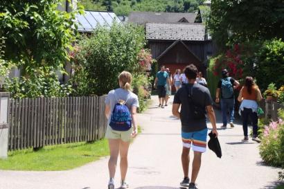 Guy and girl walking in downtown Hallstatt towards the hiking trail