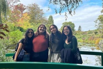 My friends and I, 4 people in total standing on a bridge in front of Monet's garden.