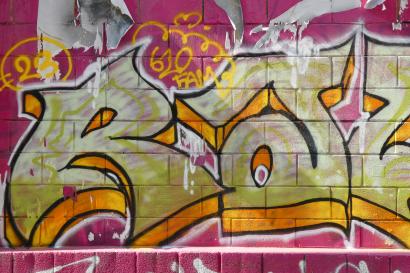 Pink, Orange, and yellow graffiti on the street of Milan