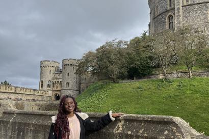 Danai standing in front of a view of one of Windsor Castle’s towers