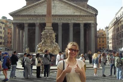 A college-aged girl poses in front of the Pantheon in Rome