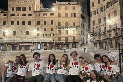 Group of students in the Piazza del Campo wearing matching "I love Siena" t-shirts