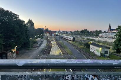 A sunsets beyond train tracks