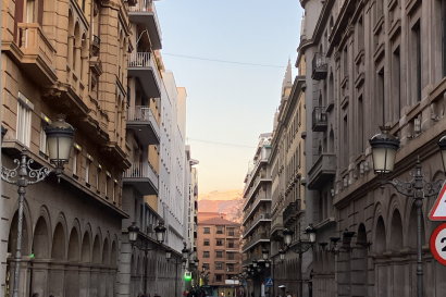 View of a street in Granada with sunset and Sierra Nevada in the background
