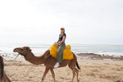 Nina Pollak riding a camel off the coast of Asilah, Morocco!
