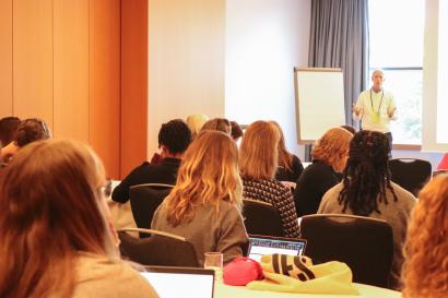 A group of people listening to a presentation