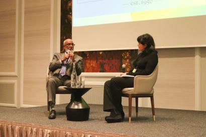 A man and a woman on stage presenting