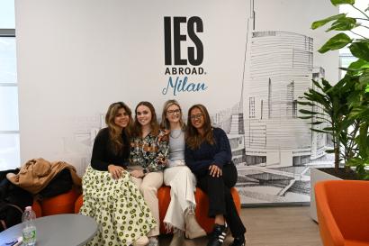 Three students sitting and smiling on a couch at the IES Abroad Milan center