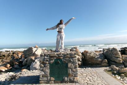 Picture of me on a structured pile of rocks with a plaque reading that where I am is Africa’s southernmost point. East of this is the Indian Ocean, and west is the Atlantic Ocean.
