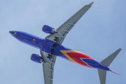 An airplane flying overhead in a blue sky