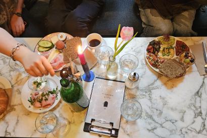 An image of a table at a café, where all sitting bodies have a plate of food except for the photographer.