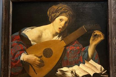 A photograph of the painting "Woman Playing the Lute" by Hendrick ter Brugghen from the Kunsthistorisches Museum in Vienna, Austria.