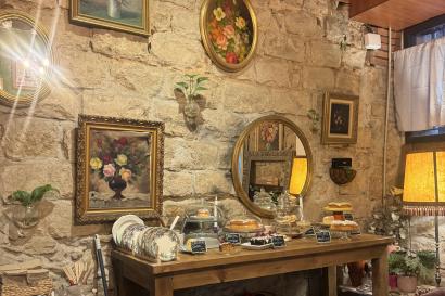 Brick wall of a cafe interior decorated with picture frames and knicknacks