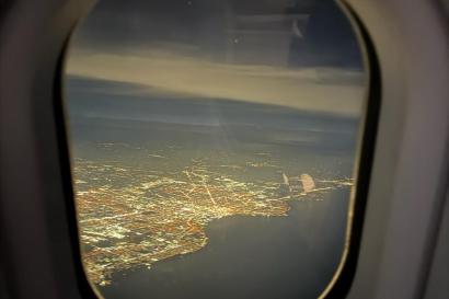 The nighttime cityscape of Chicago from a plane window.