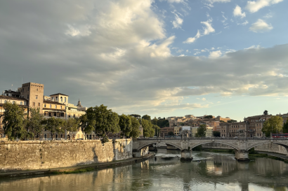 A view of Rome's historical buildings against the blue Tiber River